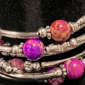 Purple and pink beads on 4 individual silver stretchable bracelets